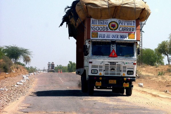 Image d'un camion surchargé sur une route en Inde