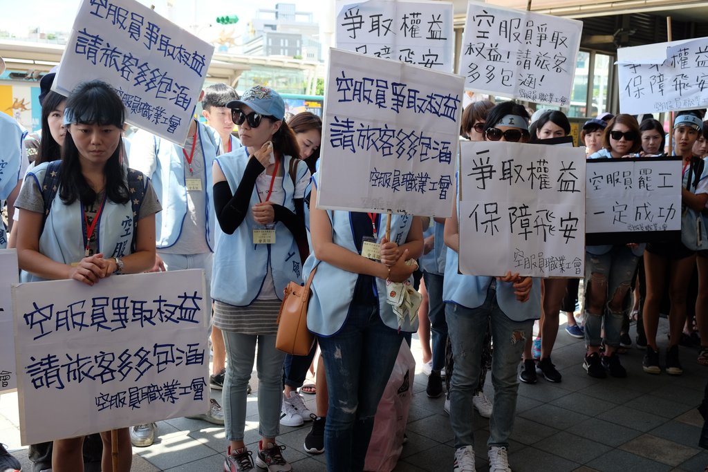 Des employées de la compagnie China Airlines en grève arborent des pancartes où l'on peut lire "Se battre pour le droit des travailleurs, c'est aussi garantir de bonnes conditions de sécurité en vol".