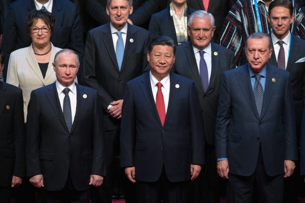 Le président chinois Xi jinxing entouré du président russe Vladimir Poutine et de son homologue turc Recep Tayyip Erdogan, avec derrière eux, l'ancien Premier ministre français Jean-Pierre Raffarin, lors du sommet international "One Belt One Road" à Pékin le 14 mai 2017. (Crédits : Sergey Guneev/POOL/Sputnik/via AFP)