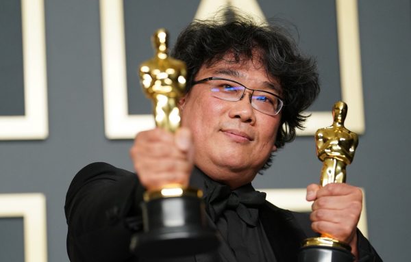 Le réalisateur sud-coréen Bong Joon-ho brandit deux des quatre oscars de son film "Parasite", récompensé dans les catégories meilleur film, meilleur film international, meilleur réalisateur et meilleur scénario original, à Los Angeles le 9 février 2020. (Source : Yahoo News)