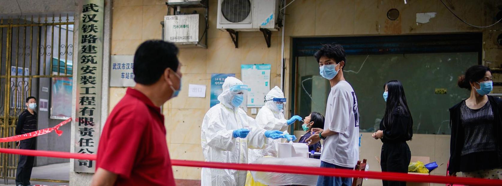 Des soignants chinois opèrent des tests d'amplification de l'acide nucléique à des résidents de Wuhan, capitale provinciale du Hubei et premier foyer officiel de la pandémie de coronavirus, le 15 mai 2020. (Source : Reuters)