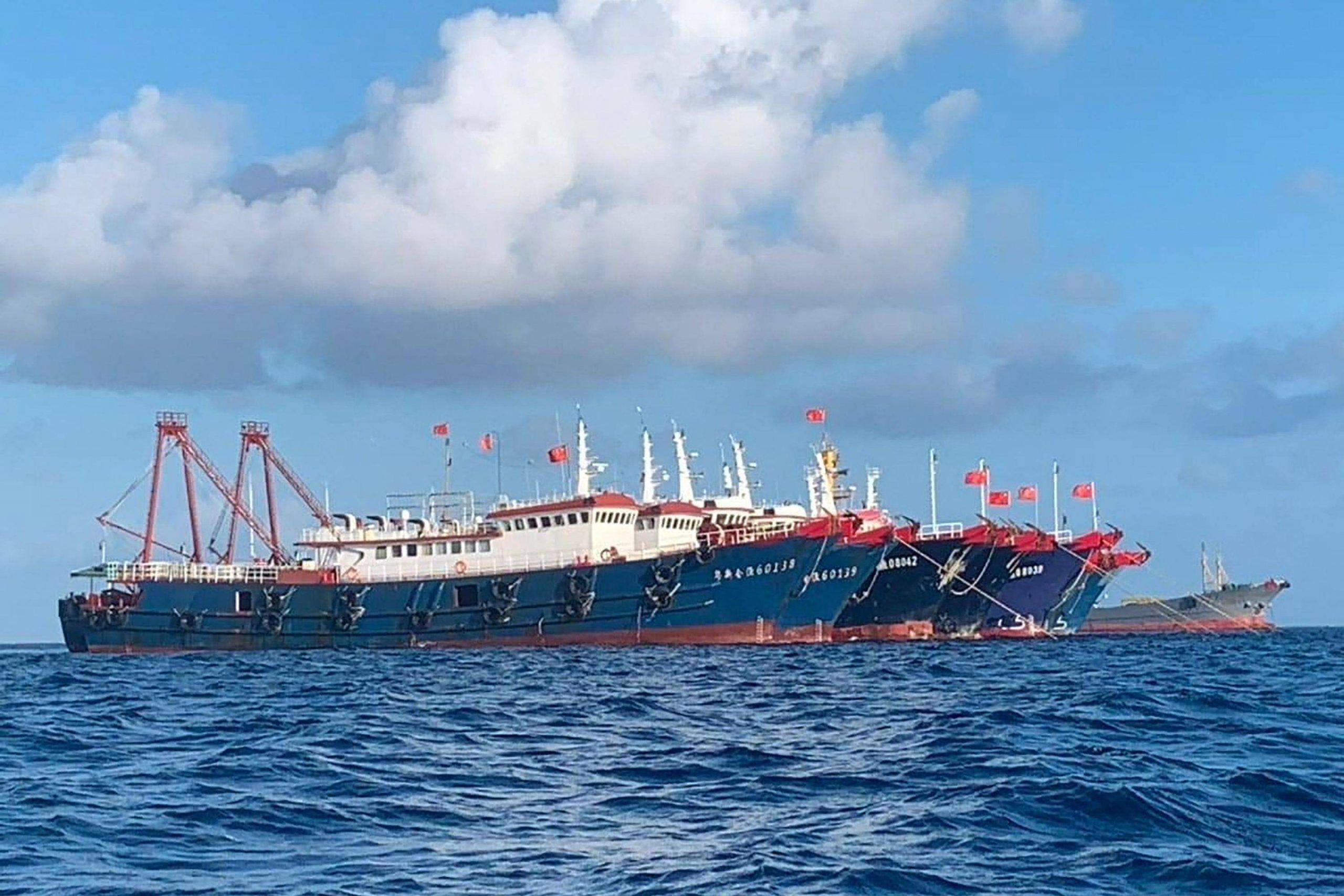 Deux des 220 navires chinois ayant jeté l'ancre au récif Whitsun, à 320 km de l'île philippine de Palawan en mer de Chine du Sud, le 27 mars 2021. (Source : Japan Times) T