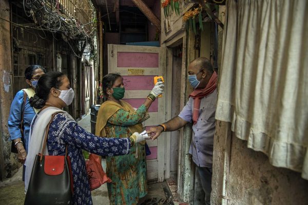 Des personnels de santé en opération de recherche des contacts de malades du Covid-19, mesurant la température du corps et le niveau d'oxygène dans le sang, à Bombay, le 15 avril 2021 en pleine deuxième vague de la pandémie en Inde. (Source : The New York Times)