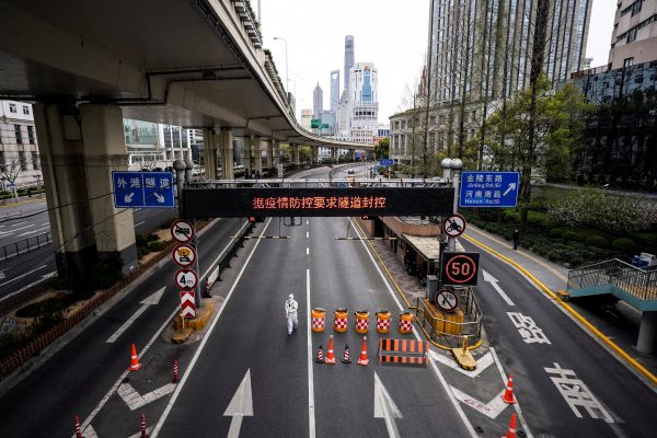 Un homme en combinaison blanche à l'entrée du tunnel menant à Pudong en traversant le fleuve Huangpu, après l'instauration de restrictions sanitaires pour contenir la pandémie de Covid-19 à Shanghai, le 28 mars 2022. (Source : NBC)
